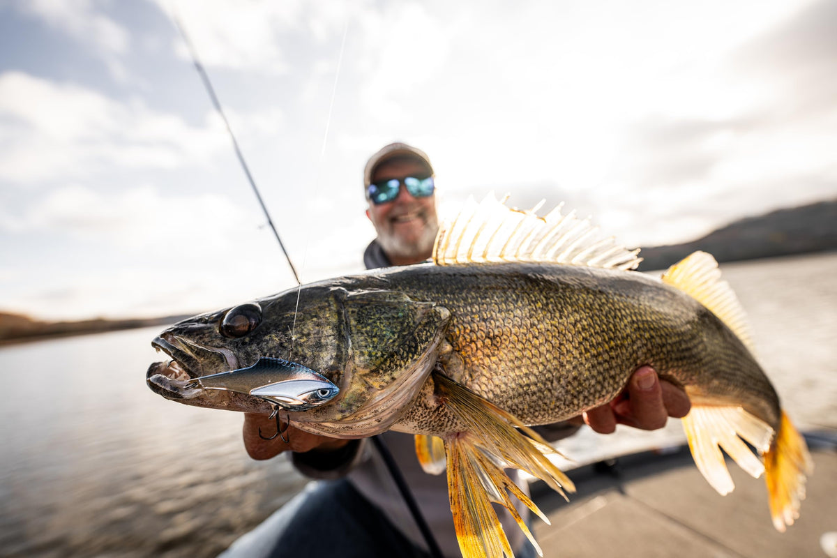Angler holding a walleye in a Rapala fishing image