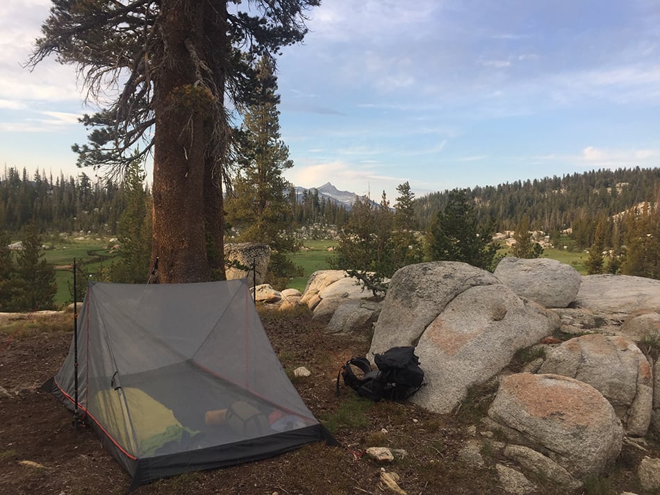 ALPS Hex 2 mesh tent body pitched beside rocks and trees