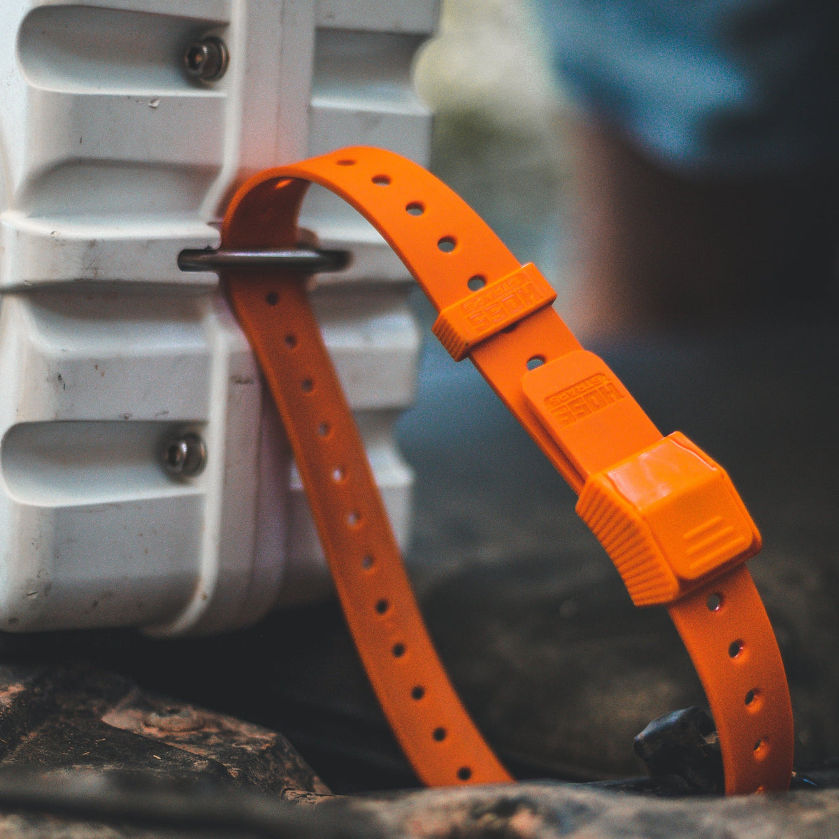 Orange Hoss gear strap hooked through a cooler handle