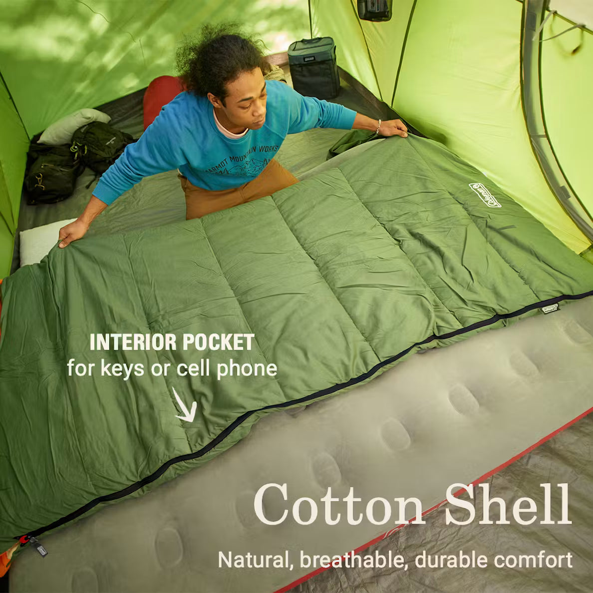 Camper inside a Coleman Big Game sleeping bag, with interior-pocket feature labels
