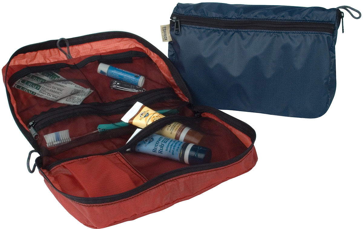 Equinox Monarch travel organizers shown open with toiletries in mesh pockets and closed in blue
