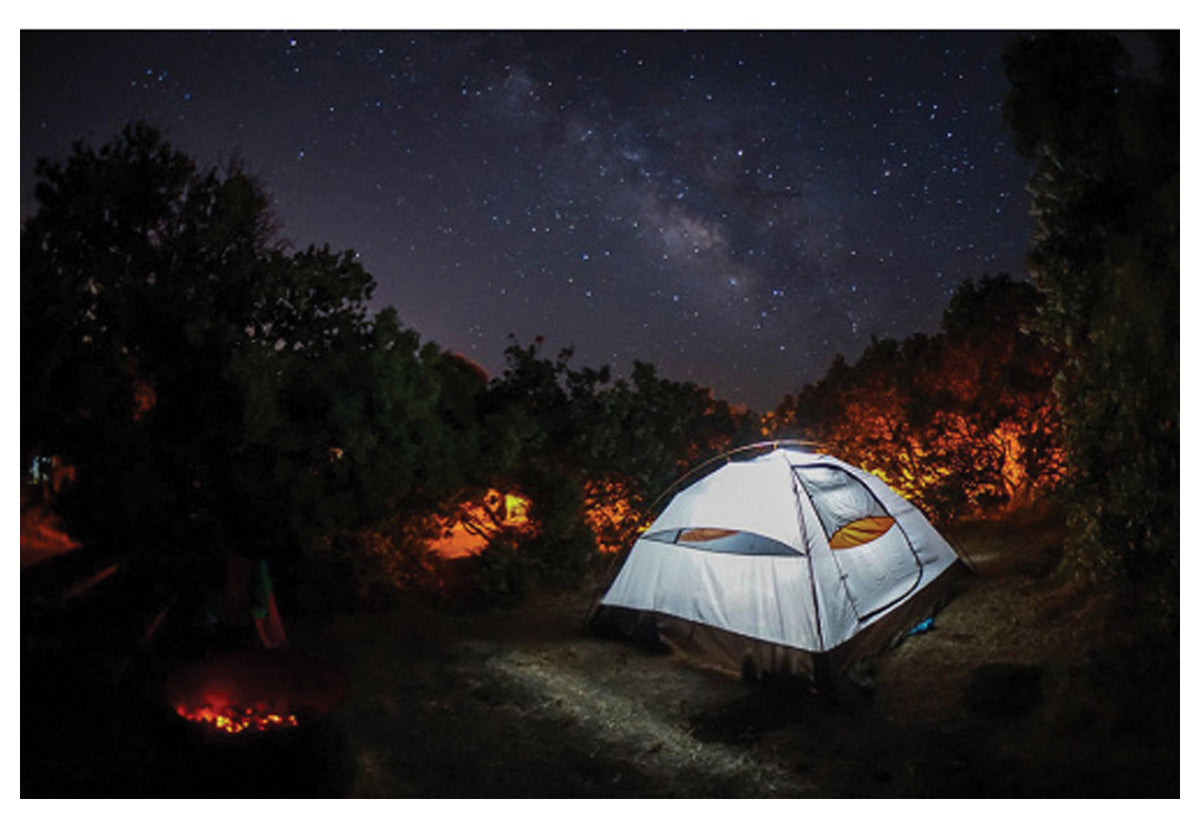 Illuminated ALPS Taurus tent pitched beneath a starry sky