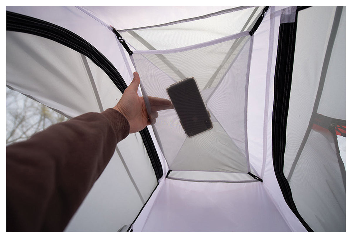 Phone being placed in an ALPS Taurus interior mesh storage pocket