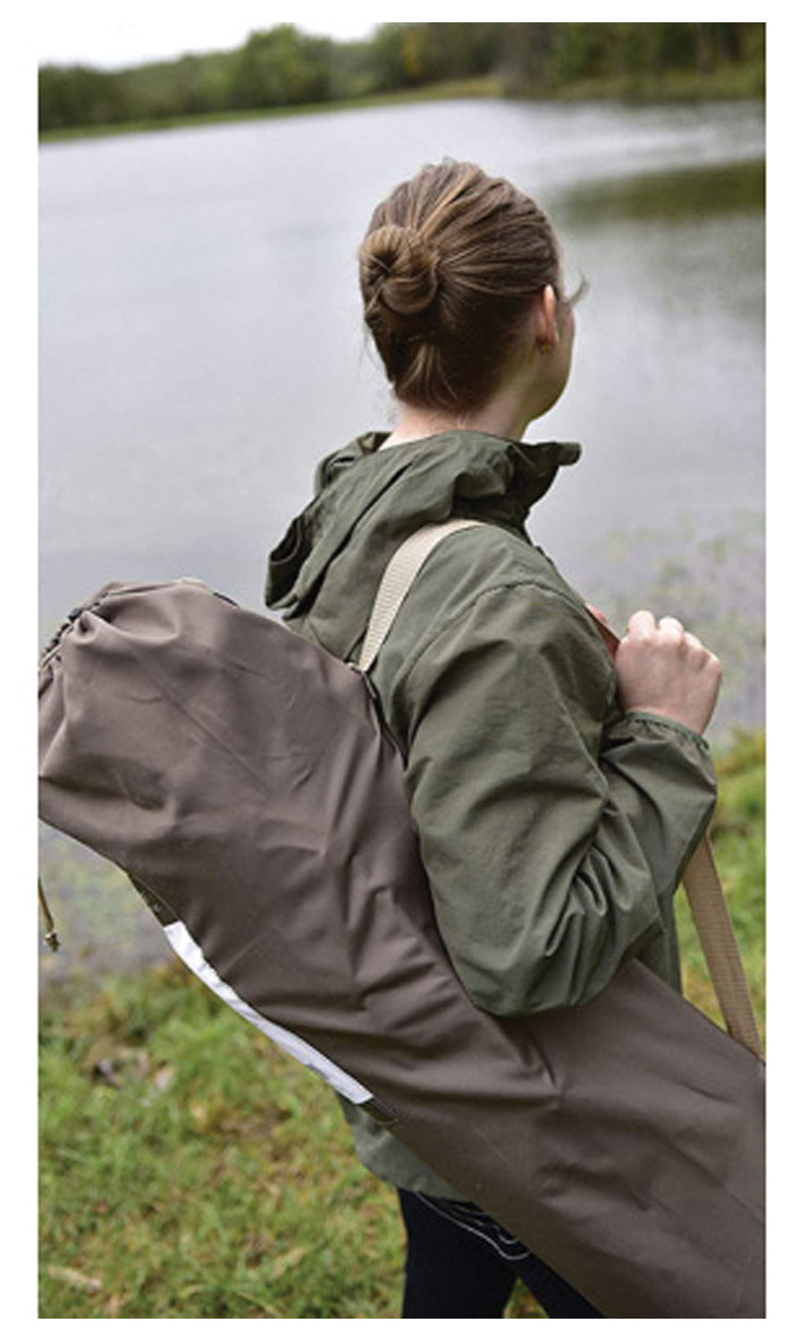 Camper carrying an ALPS Leisure chair in a shoulder bag beside a pond