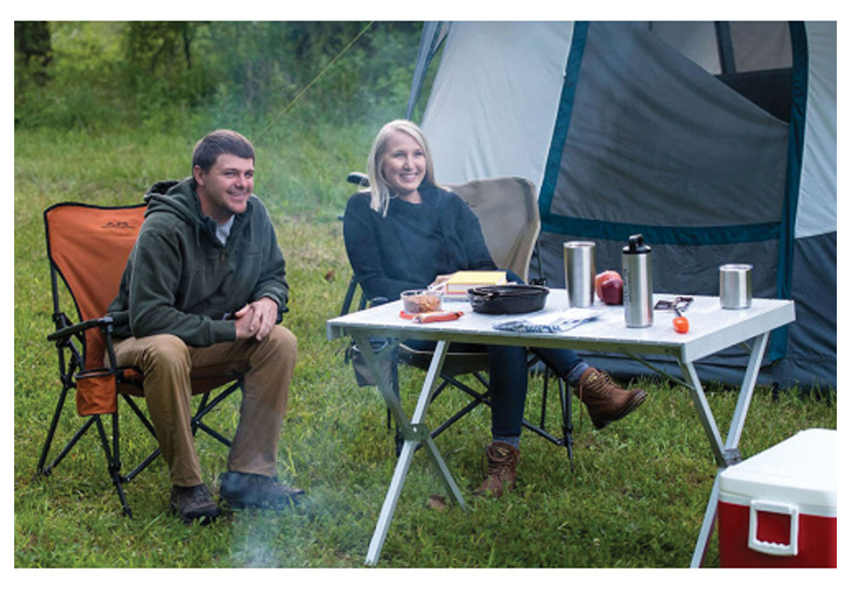 Campers sitting at an ALPS aluminum dining table set with dishes and drinks