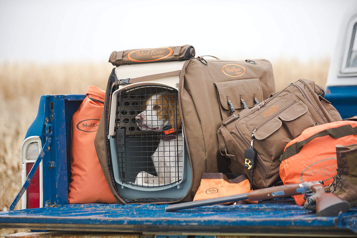 Mud River handler bag shown beside a dog crate and field equipment