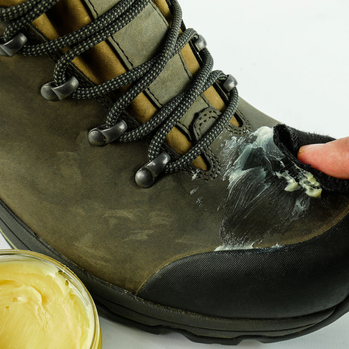 Grangers Waterproofing Wax being applied to a leather hiking boot