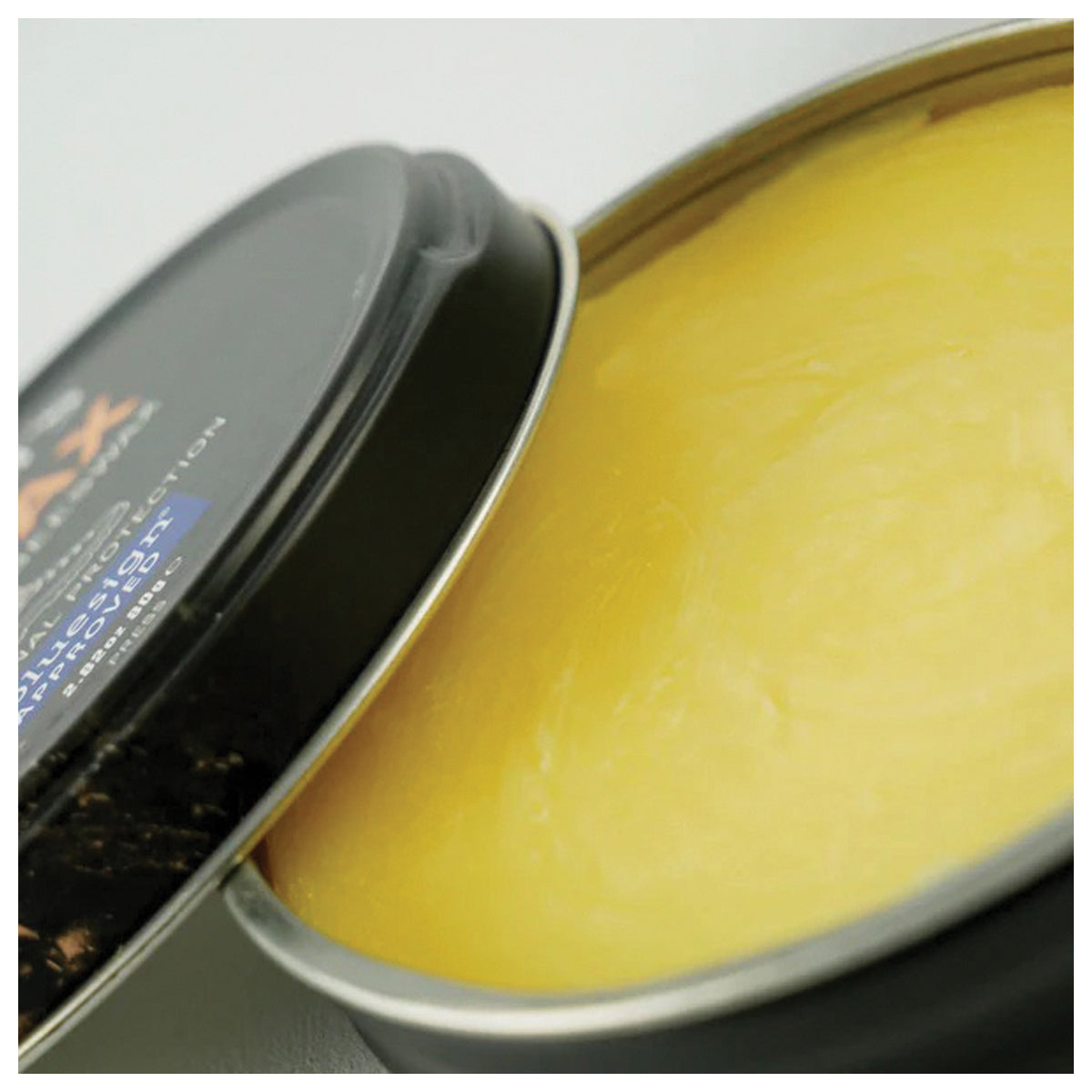 Open Grangers G-Wax container showing yellow beeswax-based treatment