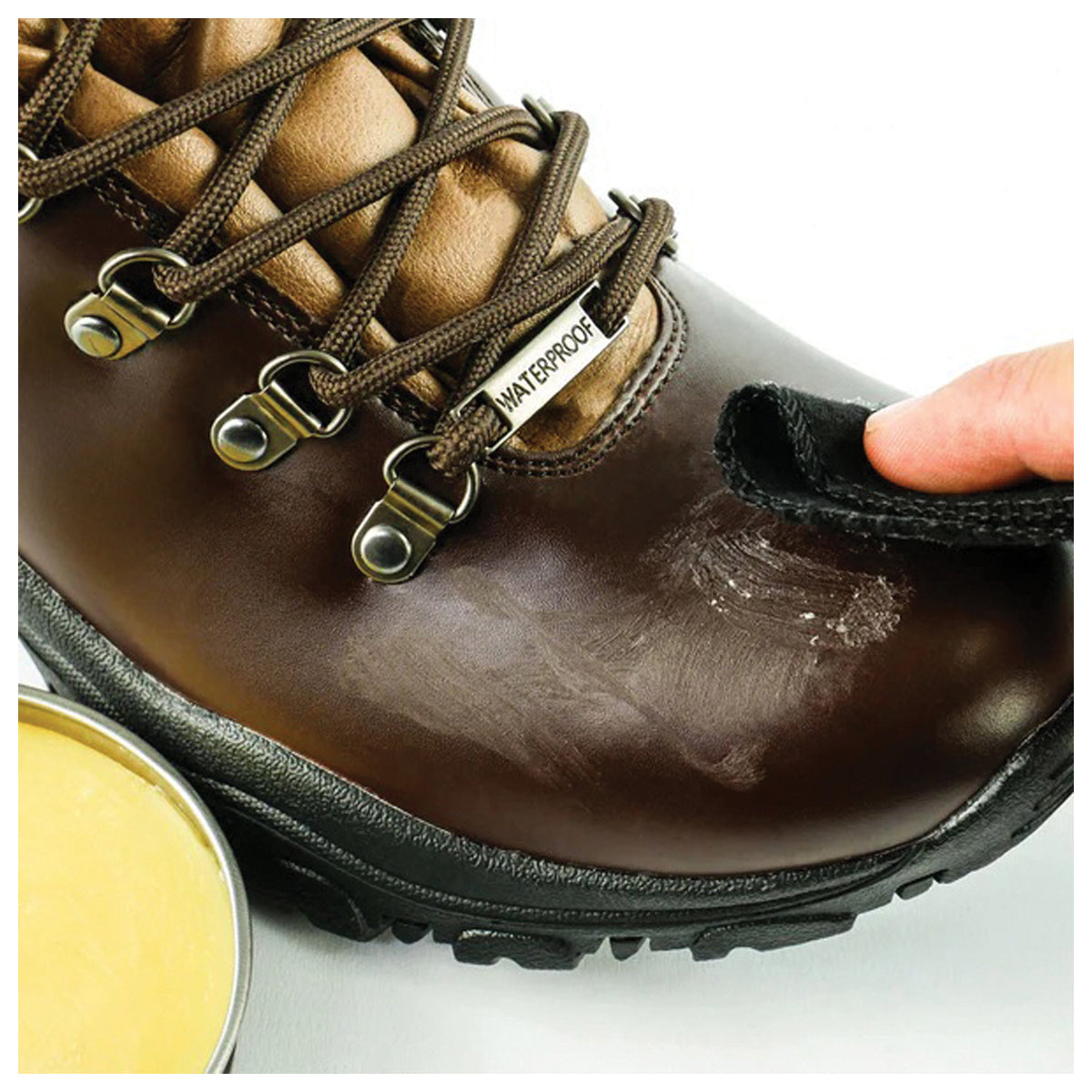 Grangers G-Wax being applied with a cloth to a brown leather boot
