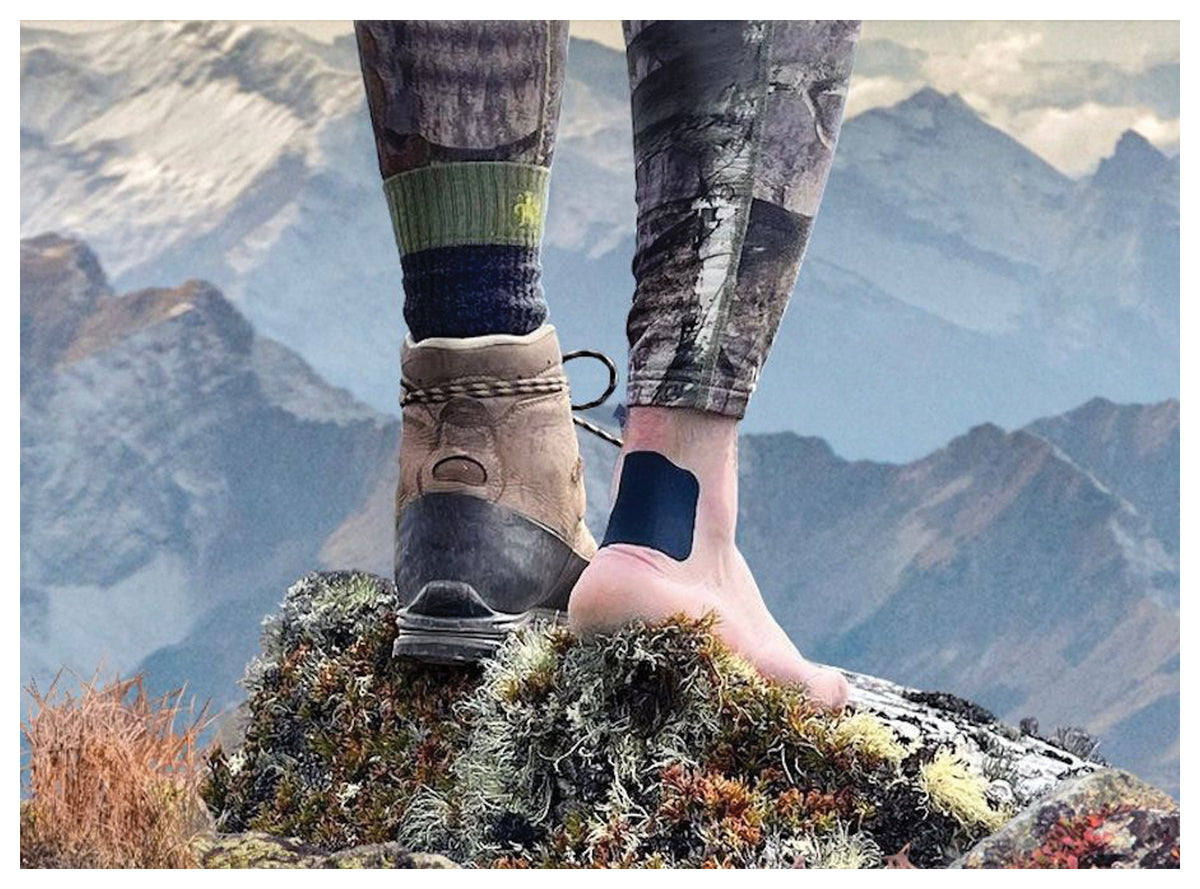 WoolAid blue bandage on a hiker's heel beside a hiking boot