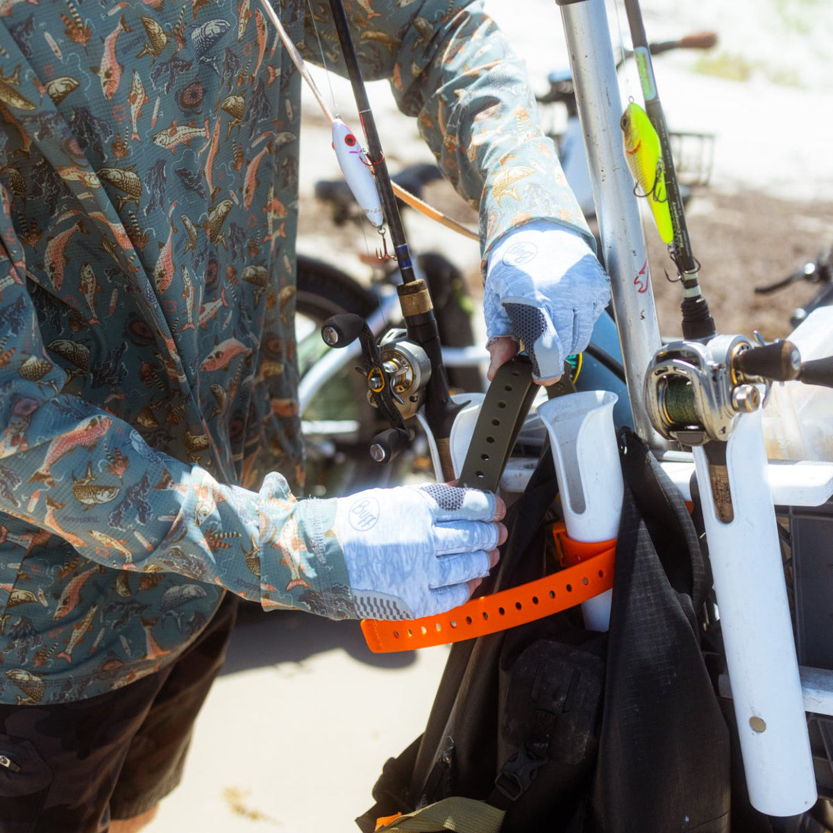 Angler securing boat equipment with an orange Hoss strap