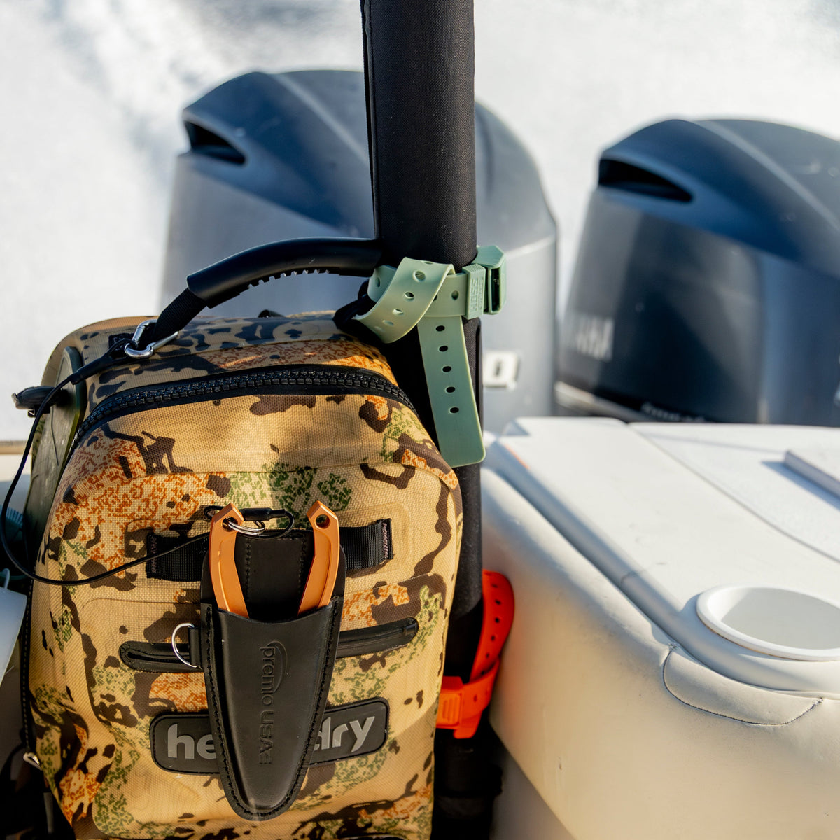 Hoss gear strap securing a pack beside boat equipment