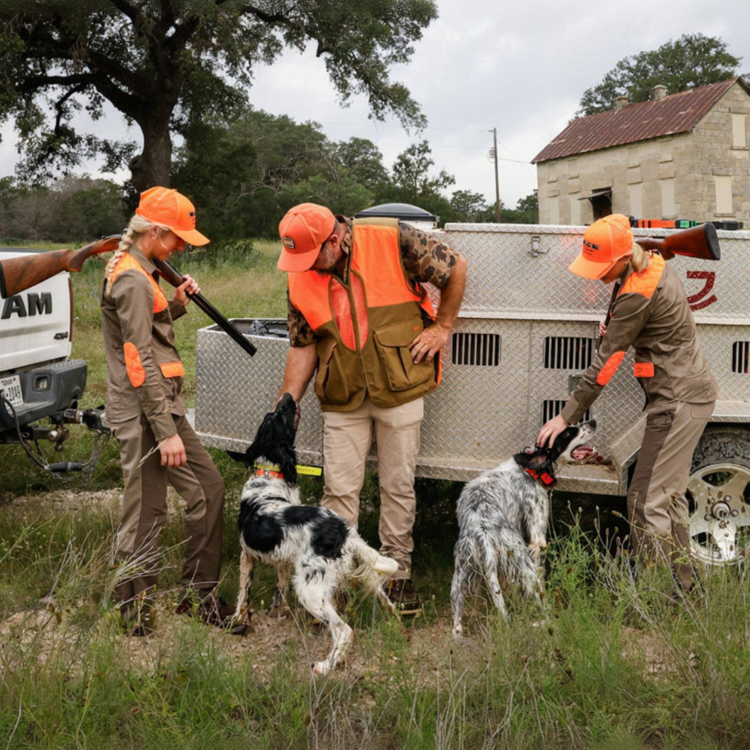 Handlers and dogs beside a vehicle with Hoss training gear