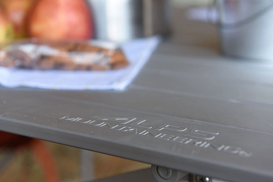 ALPS Camp Table surface close-up with embossed logo and camping cookware