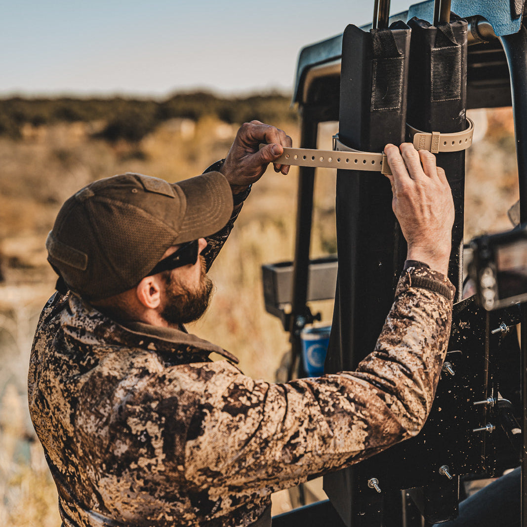 Hunter securing hunting equipment with a Hoss strap