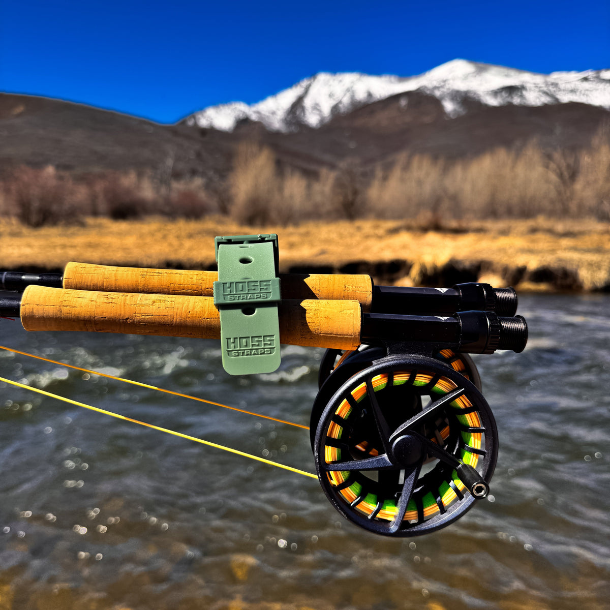 Hoss strap holding fishing rods together beside the water