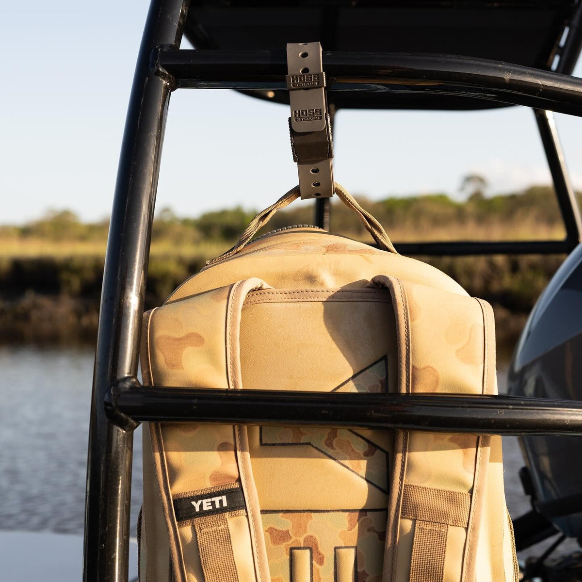 Hoss gear strap holding a tan pack on a frame