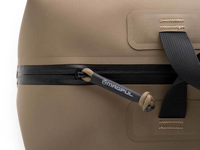 Close-up of the zipper and cord pull on a Flat Dark Earth Magpul DAKA Takeout Large bag