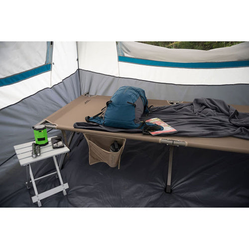 ALPS SideKick holding camp essentials beside a cot inside a tent