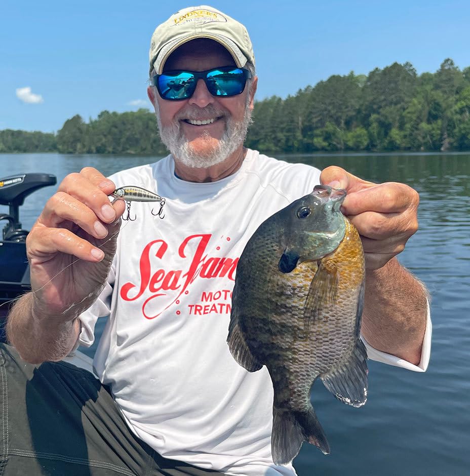 Angler holding a fish and a Rapala Countdown Elite lure