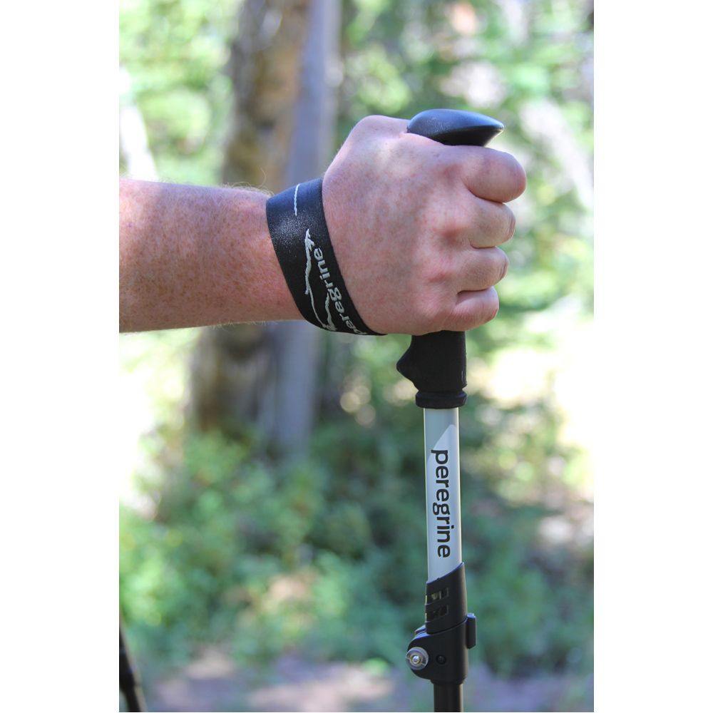 Close-up of a hand holding a Peregrine trekking pole foam grip with the wrist strap