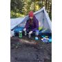 Campsite scene with a person beside a tent and cooking equipment