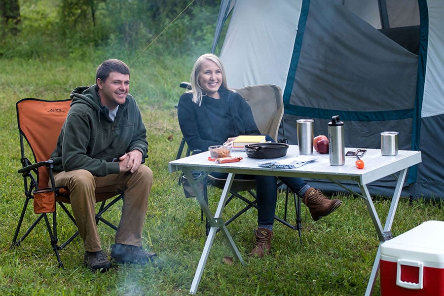 ALPS aluminum dining table set for a campsite meal beside a tent