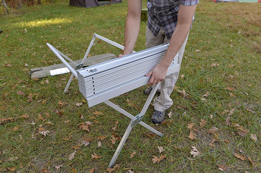 Folded slatted tabletop being removed from an ALPS aluminum dining table frame