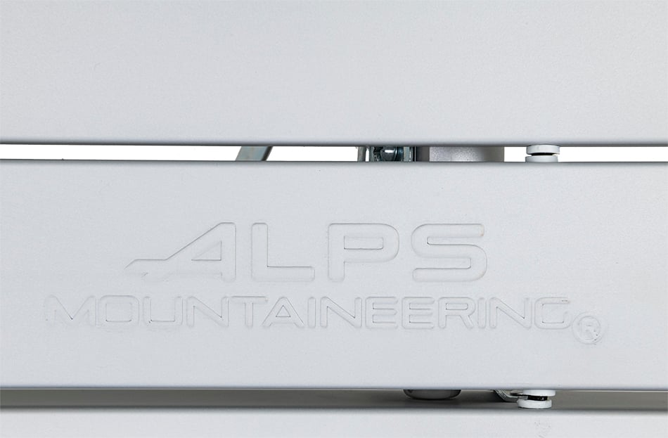 Close-up of ALPS Mountaineering logo embossed in a silver dining table slat
