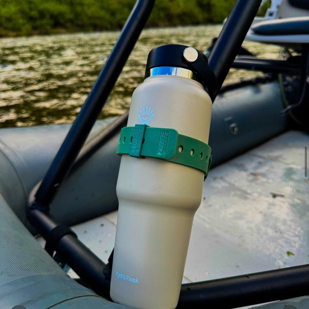 Green Hoss strap securing a bottle to a chair