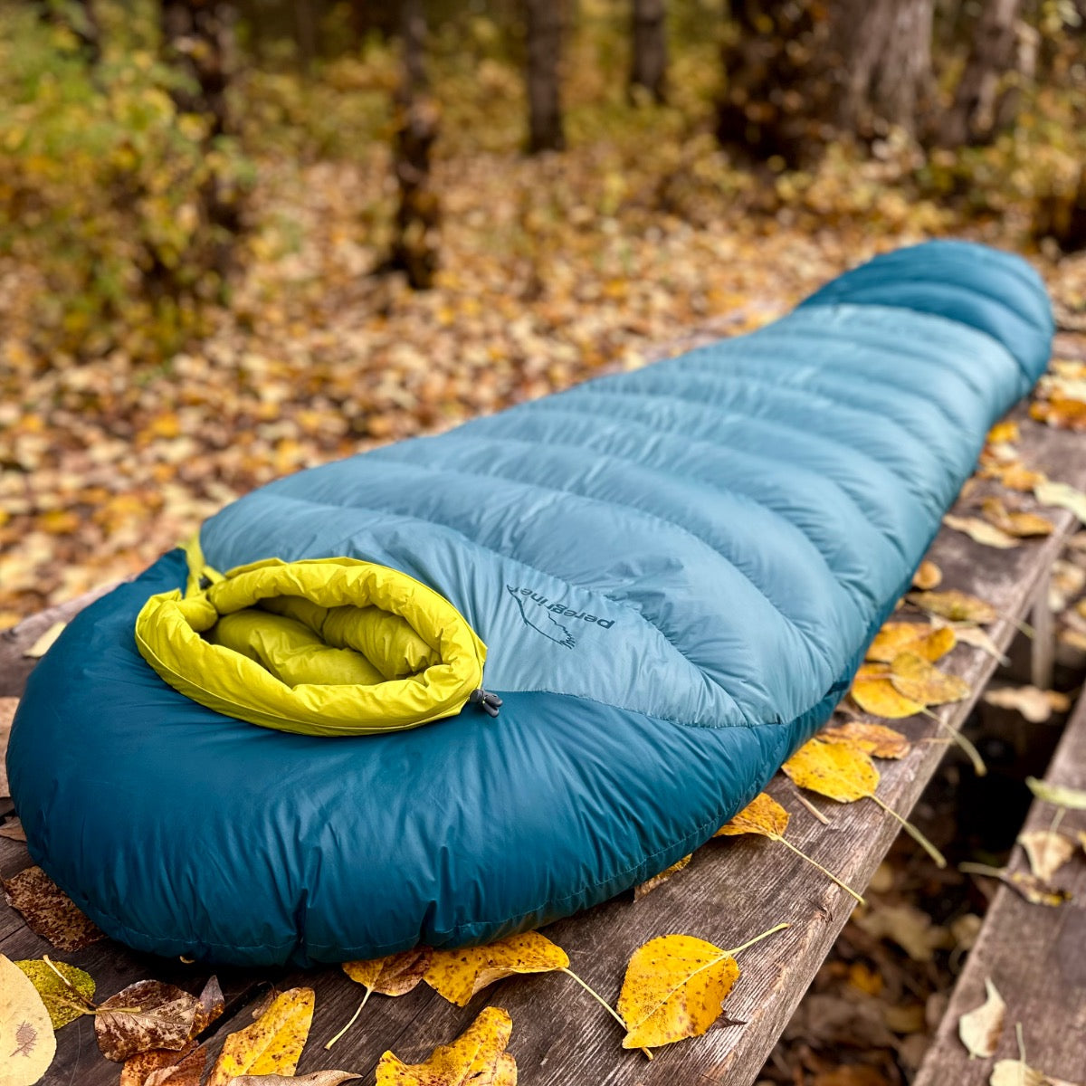 Peregrine Anatum sleeping bag laid lengthwise on a picnic table