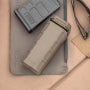Flat Dark Earth Magpul DAKA Can 2.0 on a tabletop beside other outdoor gear