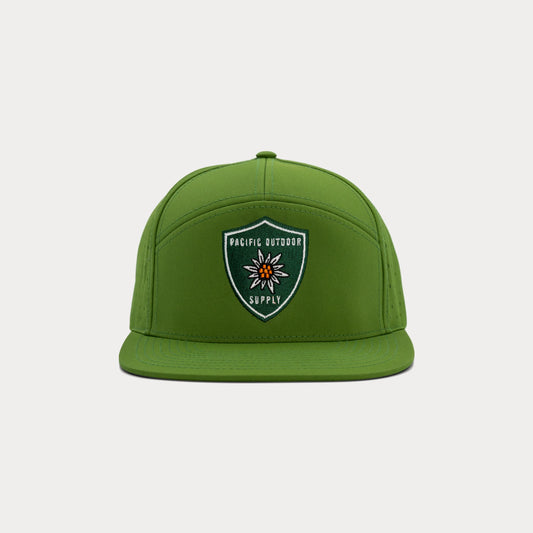 Green Pacific Outdoor Supply snapback hat with embroidered shield logo, front view