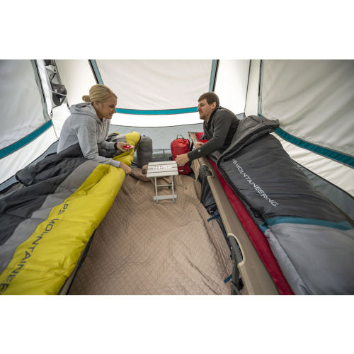 ALPS SideKick used as a small table between sleeping bags inside a tent