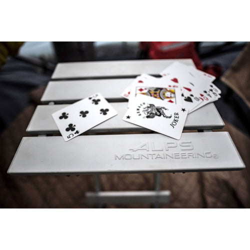 Playing cards on the silver slatted top of an ALPS SideKick table