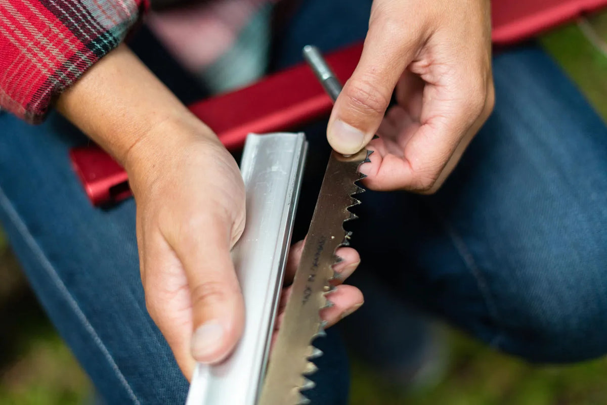 Hands assembling a Sven-Saw 21-inch folding saw