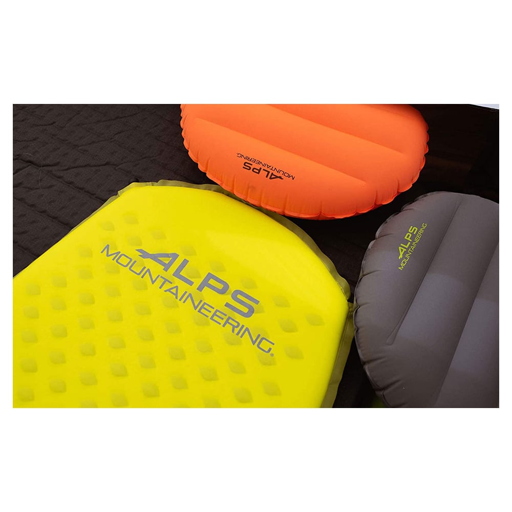 Orange and gray ALPS Versa pillows beside a yellow sleeping pad