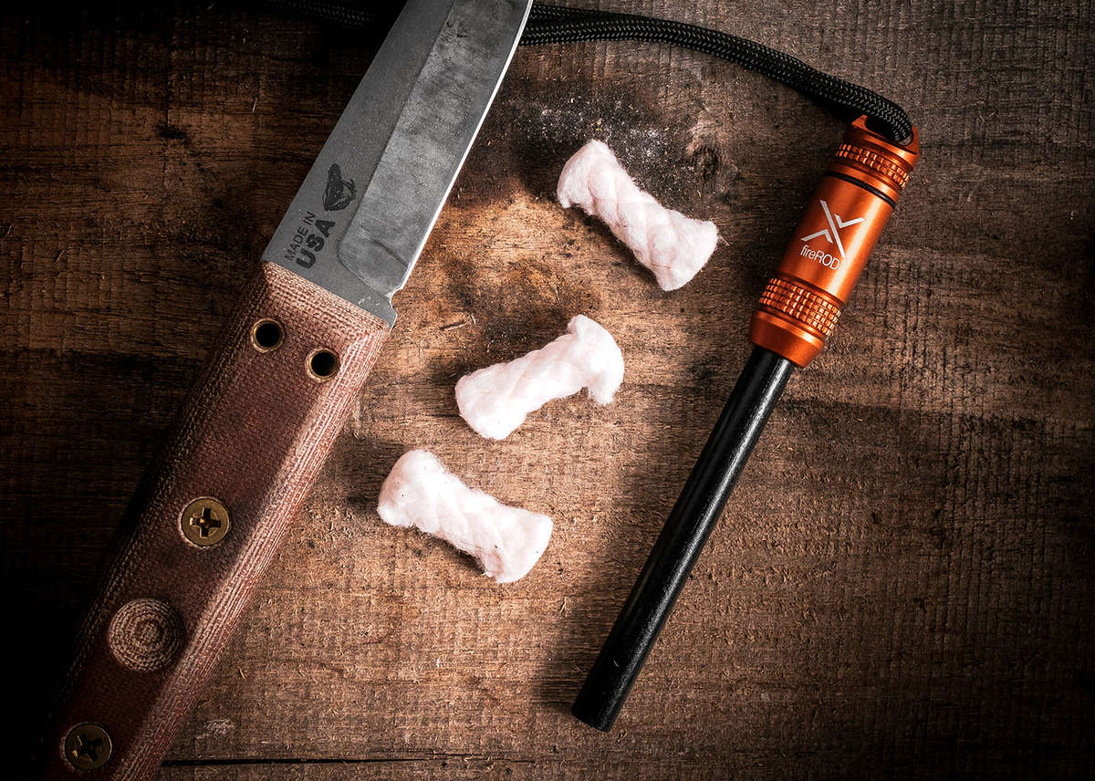 Exotac fireROD beside tinder and a knife